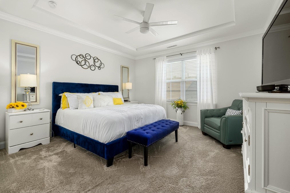 Rug vs Carpet: Why a Persian Style Rug Wins Wall-to-wall carpeting in a bedroom.