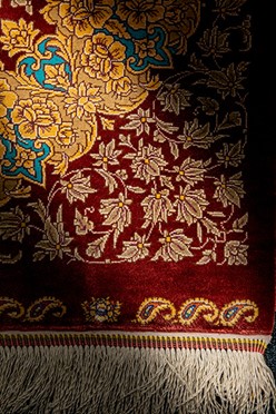 The Art of a Silk Persian Rug: History and Elegance A close examination of a silk Persian rug reveals its detailed craftsmanship and the rich depth of its traditional motifs. Photo by Robert Sciberras