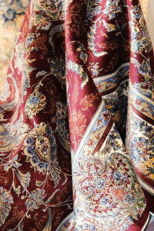 The Art of Red and Blue Persian Rugs: A Colorful Legacy A close-up view of a Persian rug, distinguished by its prominent blue and red coloration and classical motifs. Photo by Paolo Bici