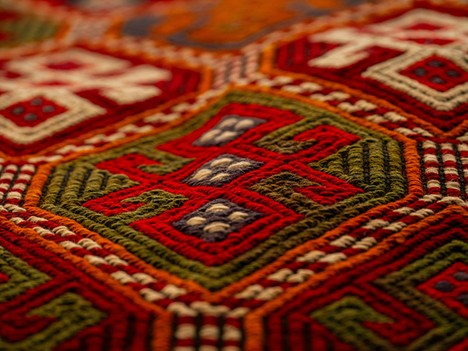 Close inspection of a rug reveals its detailed geometric design and finely textured surface. Photo by engin akyurt