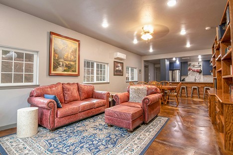 A warm and inviting living space that flows into a dining and kitchen area. The perfect spot for both relaxing and entertaining. Photo by Clay Elliot